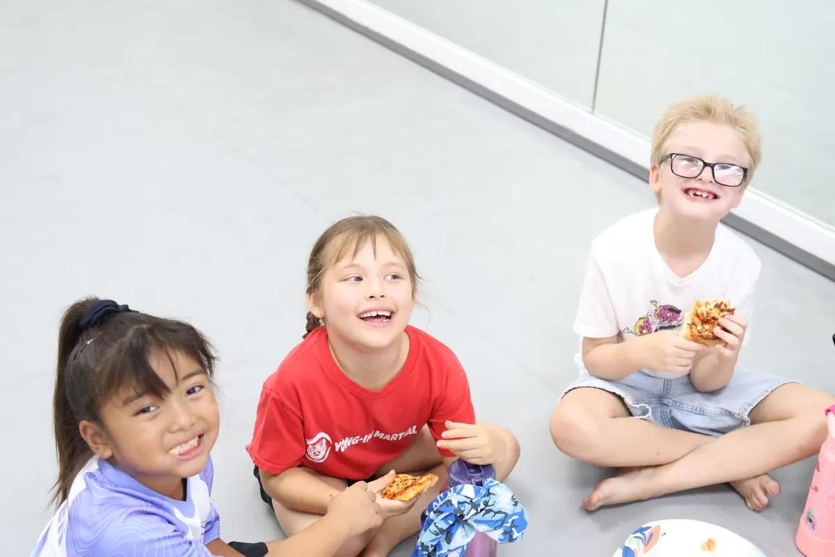 Campers having lunch together on the mat