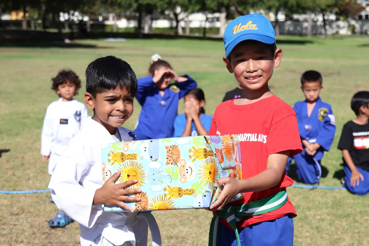 Students with a gift at a park day