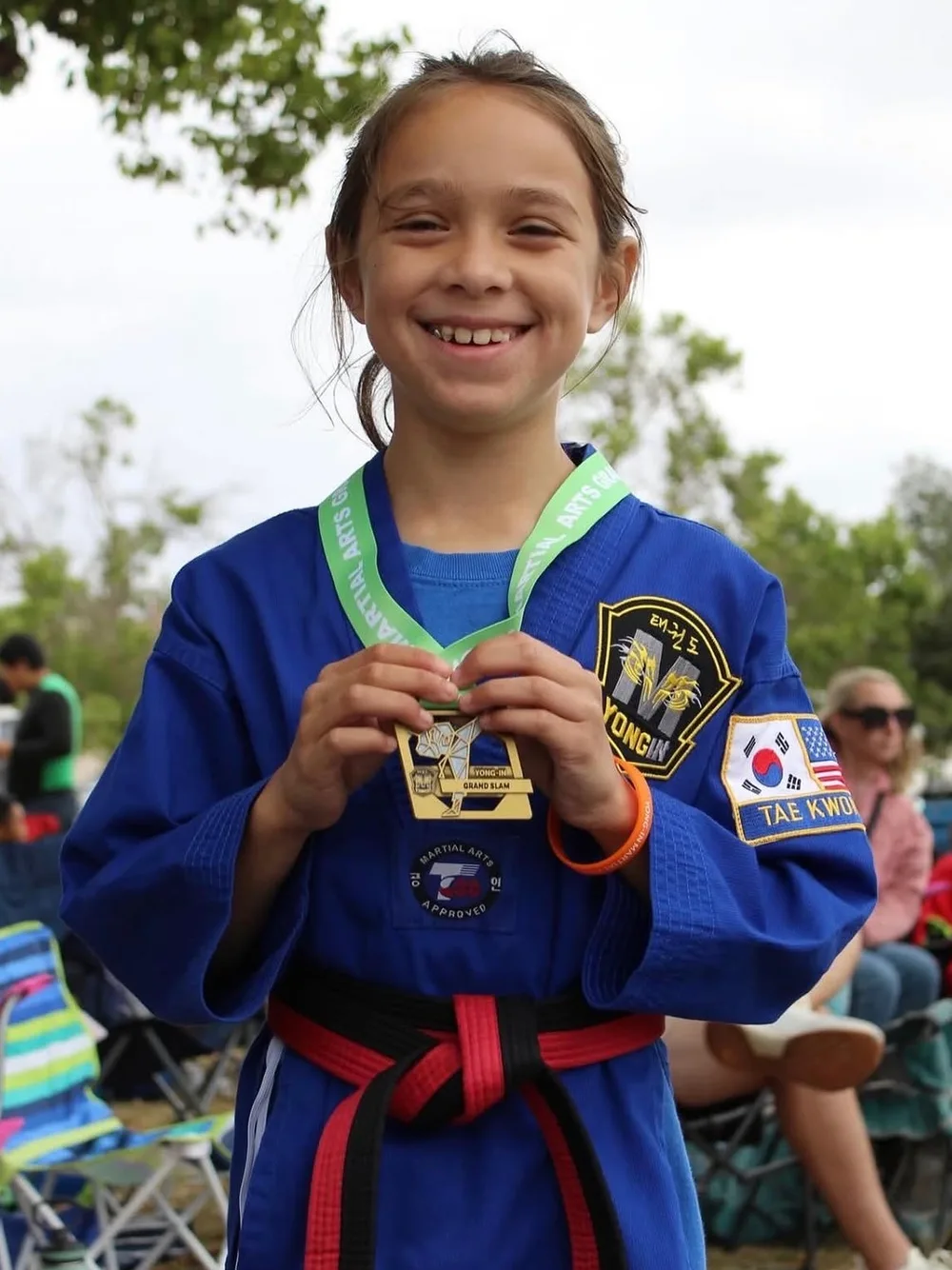 Student smiling with her tournament medal