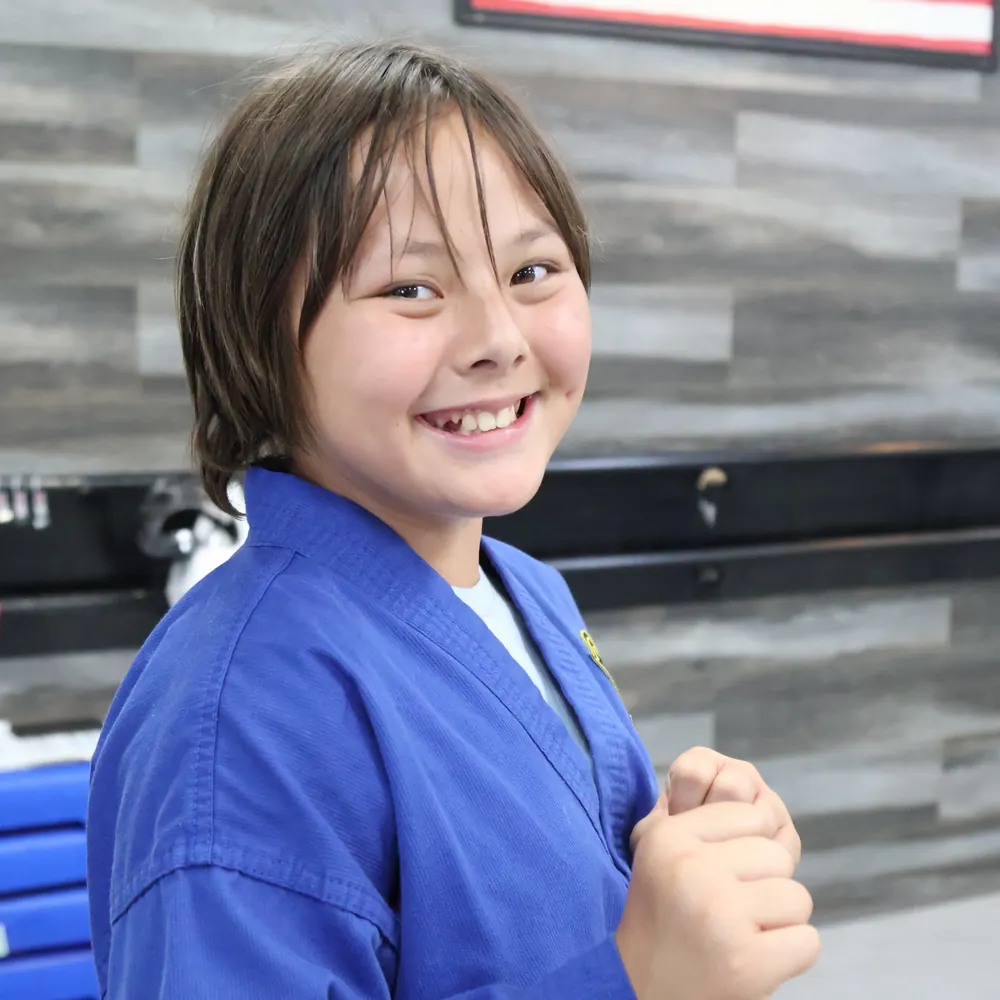 Student grinning in her blue uniform