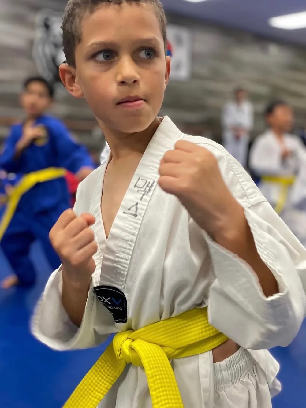Yellow belt student holding a guard position in class