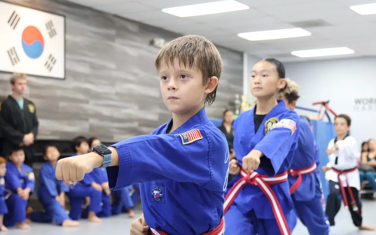 Elementary-age students practicing in blue uniforms
