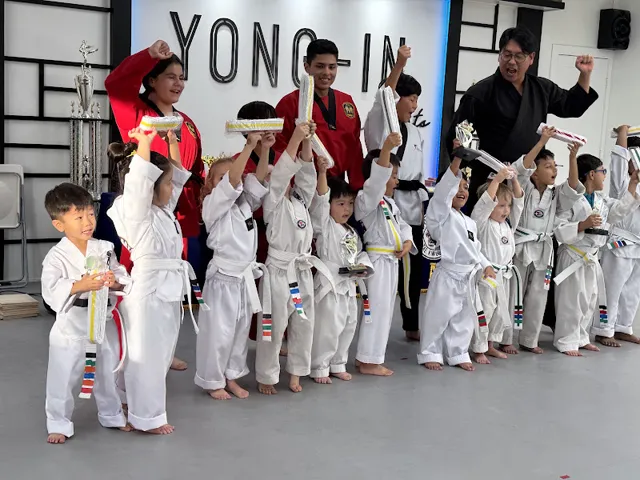 Students holding up their new belts at Lake Forest